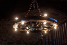 Stock Image: Elegant Fusion: Chandelier Crafted from an Old Carriage Wheel
