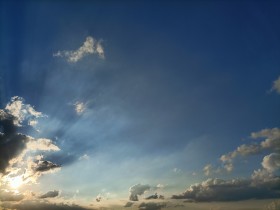 Stock Image: Epic Sky with the Sun behind a Cloud