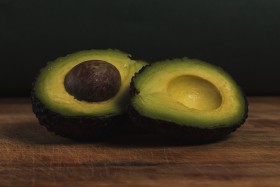 Stock Image: Fresh organic avocado on old wooden table