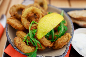 Stock Image: Fried squid rings breaded with lemon