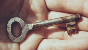 Stock Image: old key in a hand