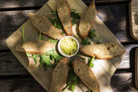 Stock Image: garlic baguette slices with guacamole dip