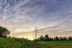 Stock Image: german rural autumn landscape marscheider bachtal in nrw power poles by sunset