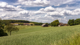 Stock Image: German rural landscape near Velbert Langenberg with fields and hills and a Farm in Background