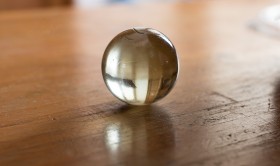 Stock Image: glass marble on a wooden table
