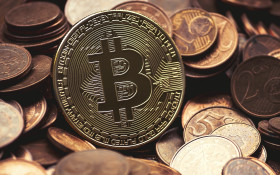 Stock Image: Golden Bitcoin between euro coins