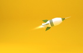Stock Image: green and white rocket on yellow background