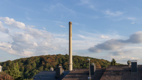 Stock Image: industrial chimney over roofs