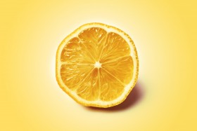 Stock Image: lemon slice yellow background