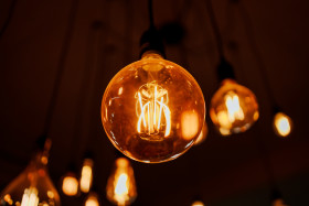 Stock Image: Light bulbs glow in the dark room
