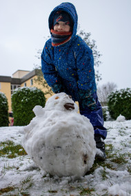 Stock Image: Little boy built a snowman