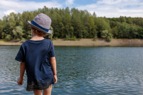 Stock Image: Little boy looks out to sea