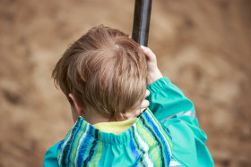 Stock Image: Little Boy on a Monkey Swing