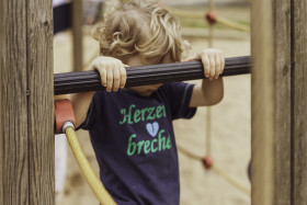 Stock Image: little boy on climbing frame on a playground