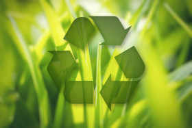 Stock Image: Lovely sunny blurred meadow with recycle symbol