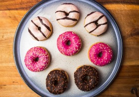 Stock Image: mixed donuts on a plate wood background