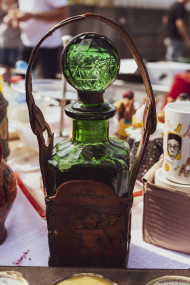 Stock Image: old beautiful green glass bottle on a flea market