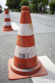 Stock Image: old striped cone on road