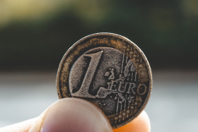 Stock Image: old used 1 euro coin in hand