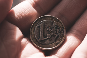 Stock Image: old used 1 euro coin in hand
