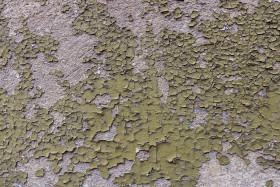 Stock Image: Old wall from which green paint is peeling off