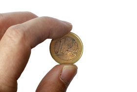 Stock Image: One euro coin in a hand isolated on a white background