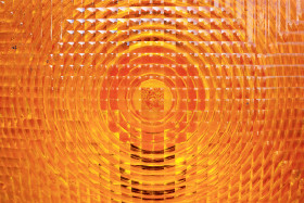 Stock Image: orange vehicle reflector texture background