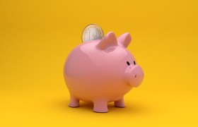 Stock Image: piggy bank yellow background