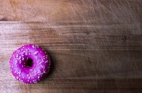 Stock Image: pink donut on wooden background
