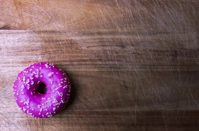 Stock Image: pink donut on wooden background