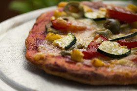 Stock Image: pizza with zucchini spinach olives corn tomatoes