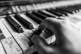 Stock Image: Playing on an old broken piano