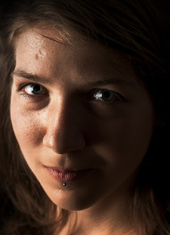 Stock Image: Portrait of a young brunette women with a piercing