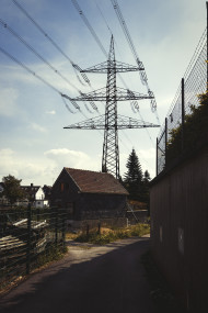 Stock Image: power pole behind a old house