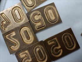 Stock Image: Precision Craftsmanship Industrial Metal Embossing Plates for Number 50 Production