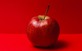 Stock Image: red apple red background