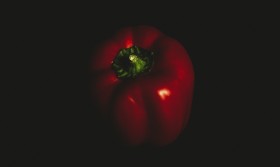 Stock Image: Red pepper on black background