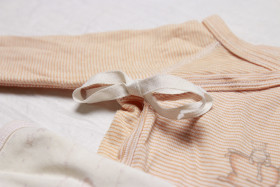 Stock Image: Ribbon on romper for babies