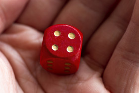 Stock Image: Roll the dice - four diced in hand