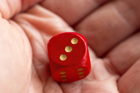 Stock Image: Roll the dice - three diced in hand