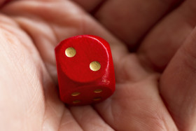 Stock Image: Roll the dice - two diced in hand