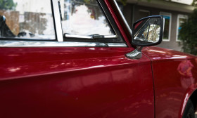 Stock Image: Side view of a red classic car