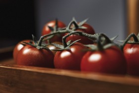 Stock Image: Small red cherry tomatoes on rustic background