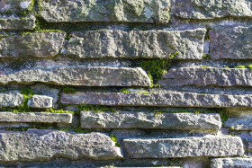 Stock Image: stone wall texture covered with moss