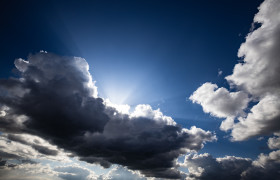 Stock Image: Sun behind clouds