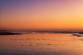 Stock Image: The lighthouse of Nazare in the distance