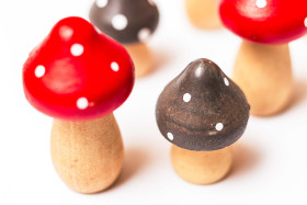 Stock Image: toadstools or fly agaric mushrooms made of wood on a white background