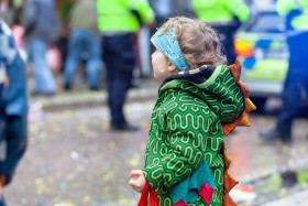 Stock Image: Toddler in dragon costume is waiting eagerly for the carnival parade