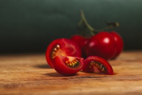 Stock Image: tomatoes sliced on a wooden board