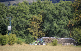 Stock Image: Tractor in a field harvests the grain